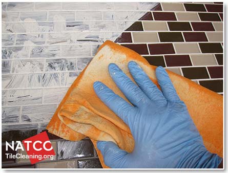 cleaning excess grout dye off of the tiles